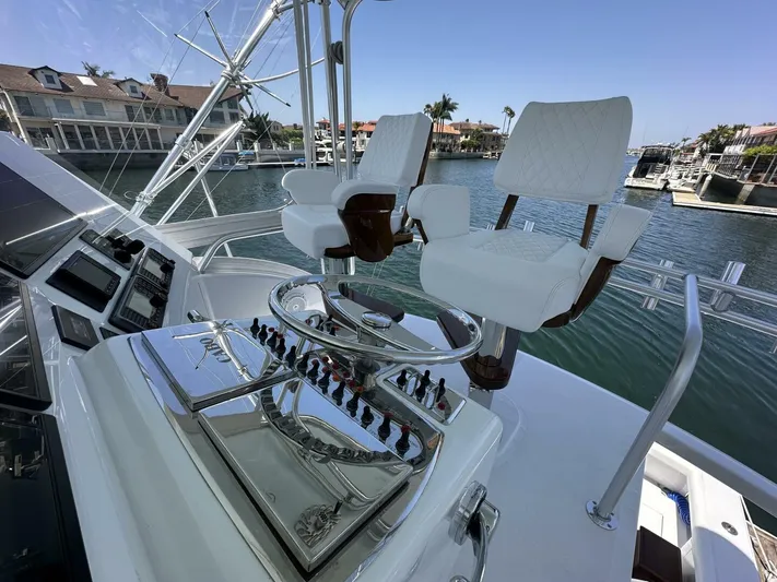 Off Season Yacht Photos Pics Helm of 2006 Cabo 48 Convertible yacht with dual captain chairs and control panel.