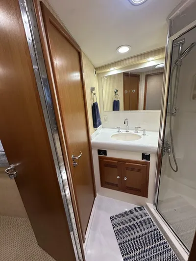 Off Season Yacht Photos Pics Bathroom interior of 2006 Cabo 48 Convertible yacht with sink and shower.