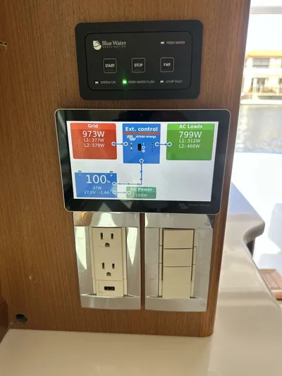 Off Season Yacht Photos Pics Control panel on 2006 Cabo 48 Convertible yacht displaying power usage and outlets.