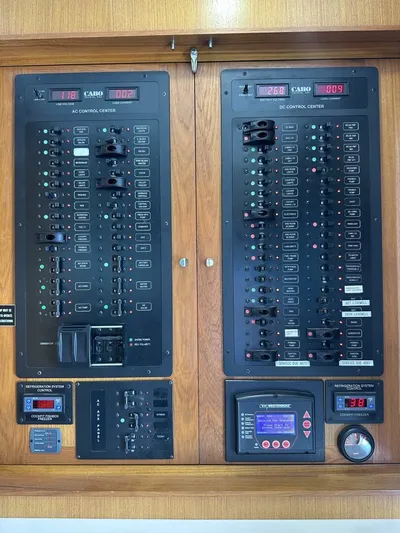 Off Season Yacht Photos Pics Electrical control panel on a 2006 Cabo 48 Convertible yacht, featuring AC and DC systems.