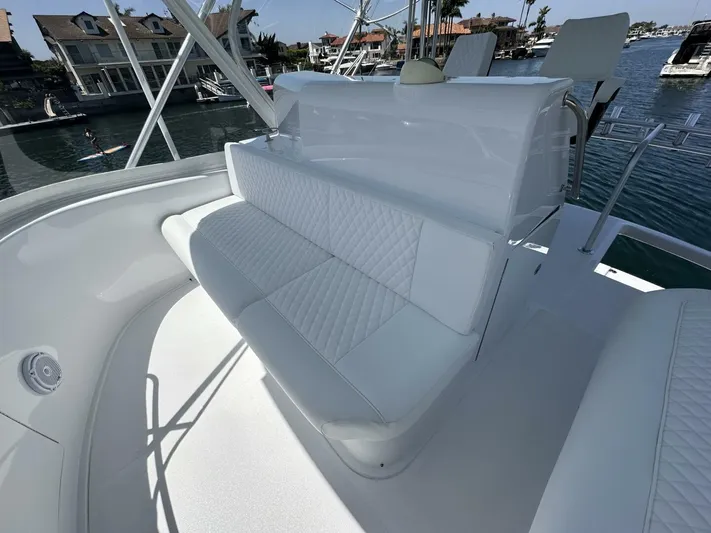 Off Season Yacht Photos Pics Luxurious seating on a 2006 Cabo 48 Convertible yacht, docked near waterfront homes.