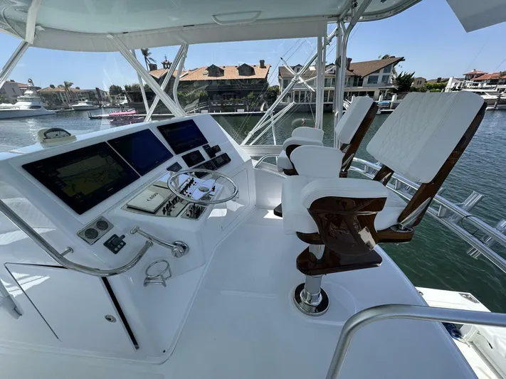 Off Season Yacht Photos Pics Helm of 2006 Cabo 48 Convertible yacht with dual captain chairs and navigation screens.