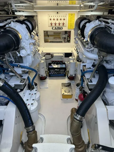 Off Season Yacht Photos Pics Engine room of a 2006 Cabo 48 Convertible yacht, showcasing dual engines and control panel.