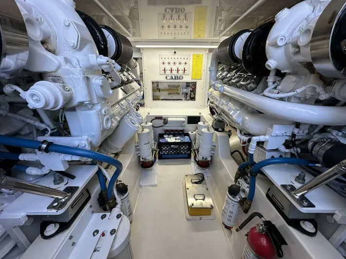 Off Season Yacht Photos Pics Engine room of a 2006 Cabo 48 Convertible yacht, showcasing dual engines and mechanical components.