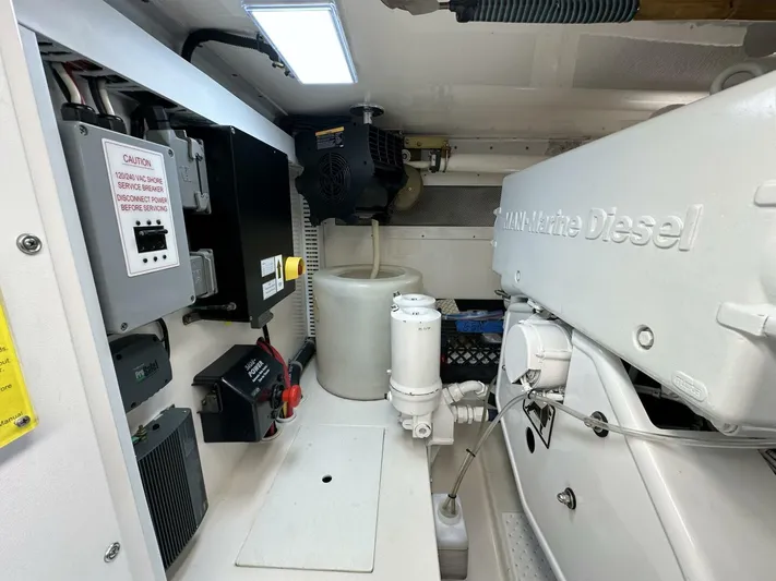 Off Season Yacht Photos Pics Engine room of 2006 Cabo 48 Convertible with MAN Marine Diesel engine components.