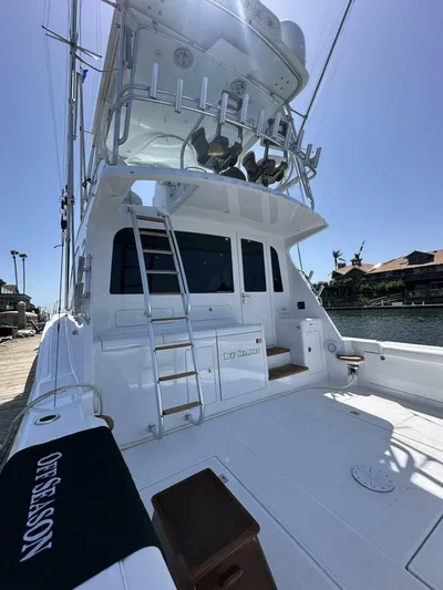 Off Season Yacht Photos Pics 2006 Cabo 48 Convertible yacht with ladder and seating, docked under clear blue sky.