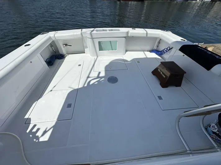 Off Season Yacht Photos Pics Spacious deck of 2006 Cabo 48 Convertible yacht, featuring clean white surface and dockside view.