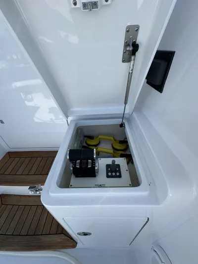 Off Season Yacht Photos Pics Open hatch on 2006 Cabo 48 Convertible boat, revealing mechanical components.