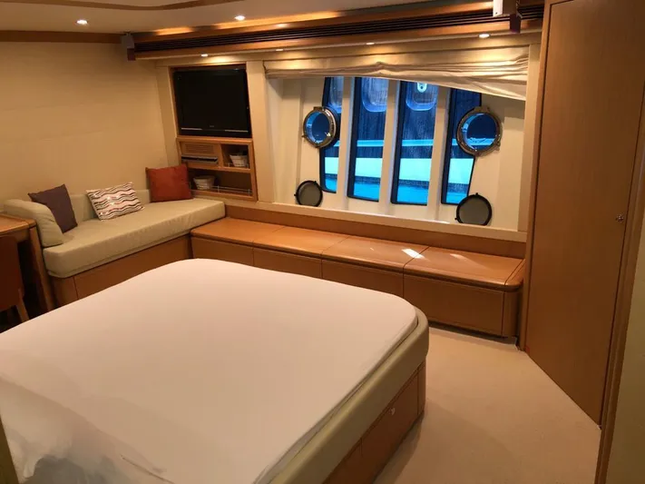 Mar Azul Yacht Photos Pics Luxurious bedroom interior of 2008 Ferretti Yachts 830 with elegant furnishings and porthole windows.