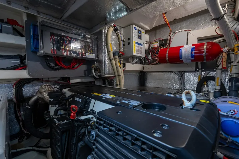 O Sea D Yacht Photos Pics Engine room of 2017 Absolute 50 Fly yacht with visible machinery and fire extinguisher.