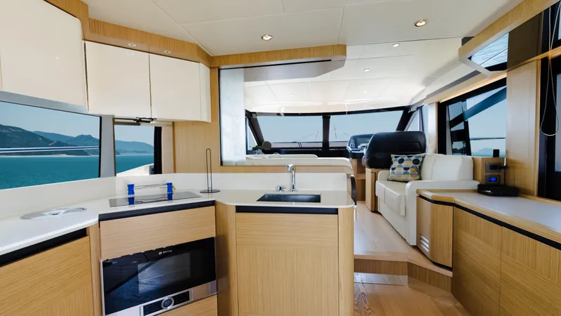 O Sea D Yacht Photos Pics Luxurious interior of a 2017 Absolute 50 Fly yacht with modern kitchen and seating area.
