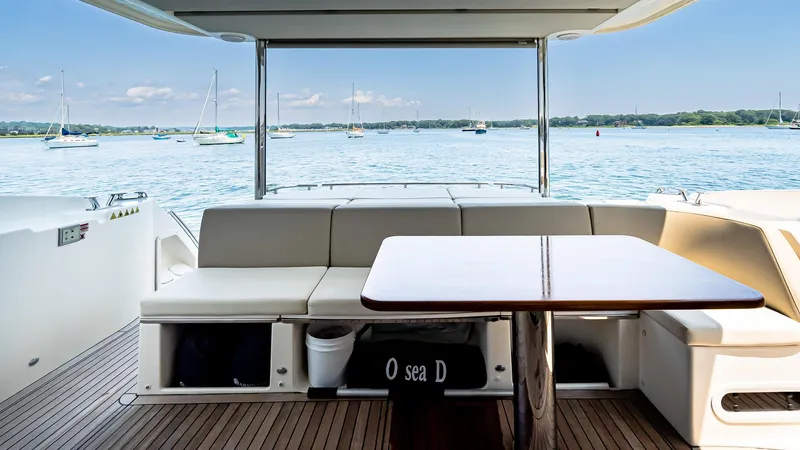 O Sea D Yacht Photos Pics Luxurious 2017 Absolute 50 Fly yacht deck with seating and table, overlooking serene waters.