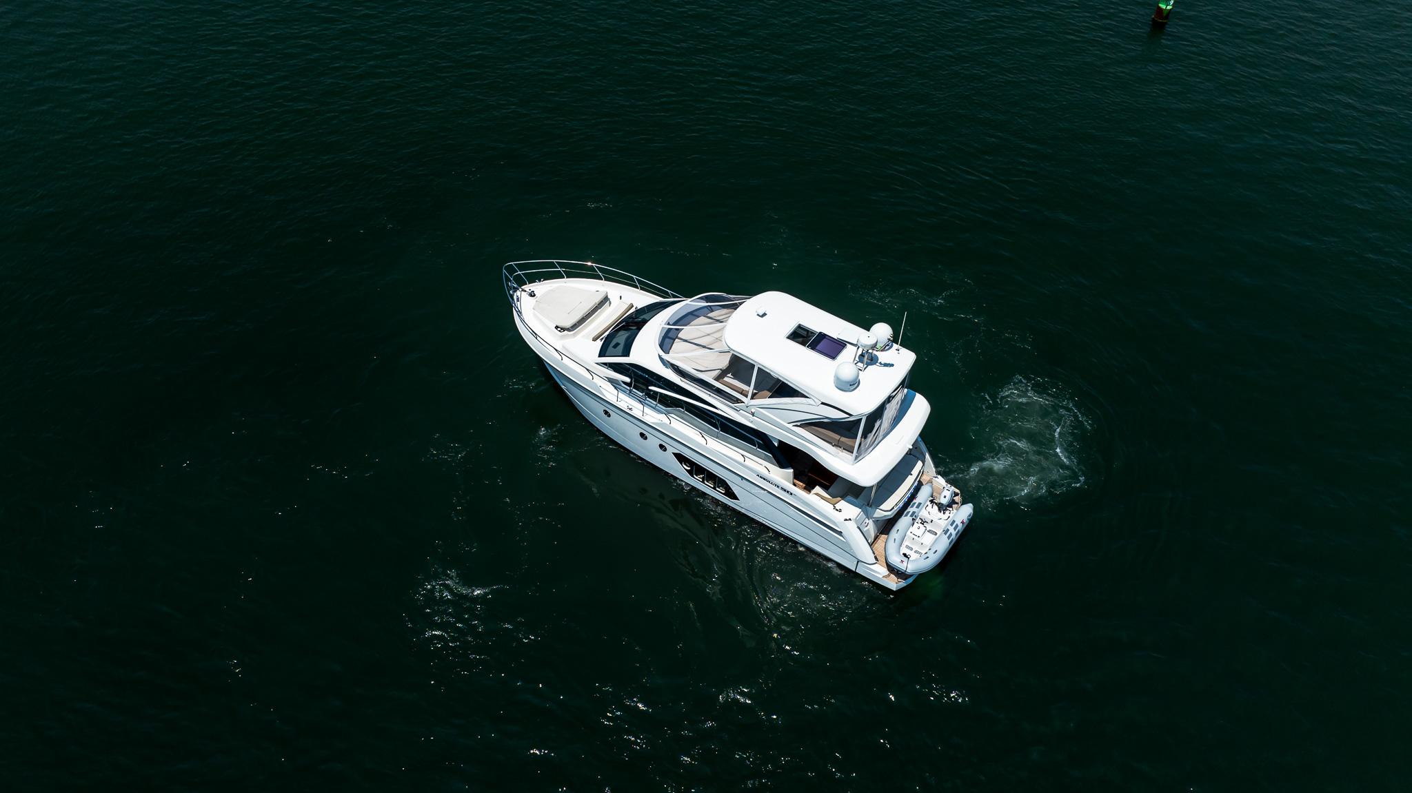 Aerial view of 2017 Absolute 50 Fly yacht cruising on open water.