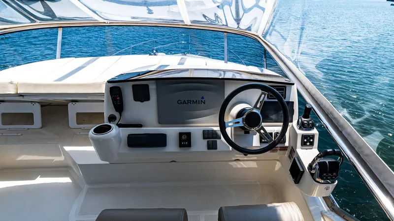 O Sea D Yacht Photos Pics Cockpit of 2017 Absolute 50 Fly yacht with Garmin navigation system, steering wheel, and ocean view.