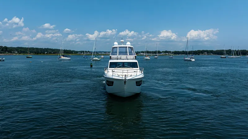 O Sea D Yacht Photos Pics 2017 Absolute 50 Fly yacht on calm water with sailboats in the background.