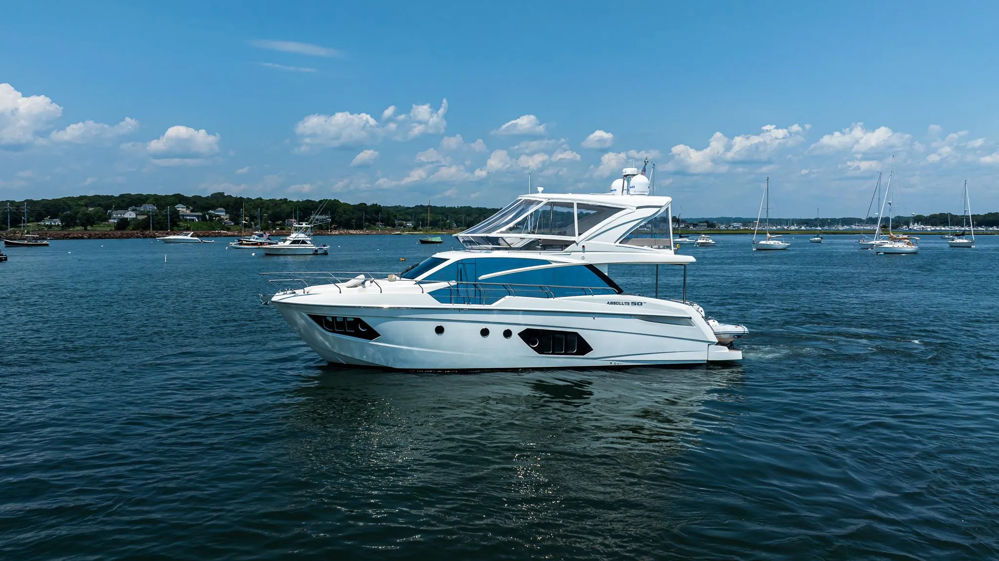 Luxurious 2017 Absolute 50 Fly yacht cruising on a serene, sunny day.