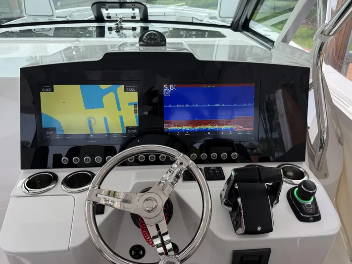  Yacht Photos Pics 2023 Bertram 39 CC helm with dual Garmin displays and modern controls.