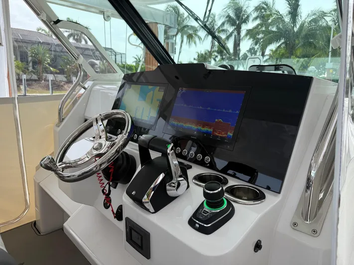  Yacht Photos Pics 2023 Bertram 39 CC helm with modern controls and dual navigation screens.