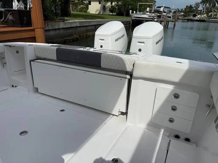  Yacht Photos Pics 2023 Bertram 39 CC boat interior with seating and Mercury engines in a marina setting.