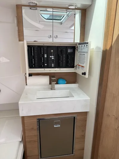  Yacht Photos Pics 2023 Bertram 39 CC yacht interior with modern sink and electrical panel.