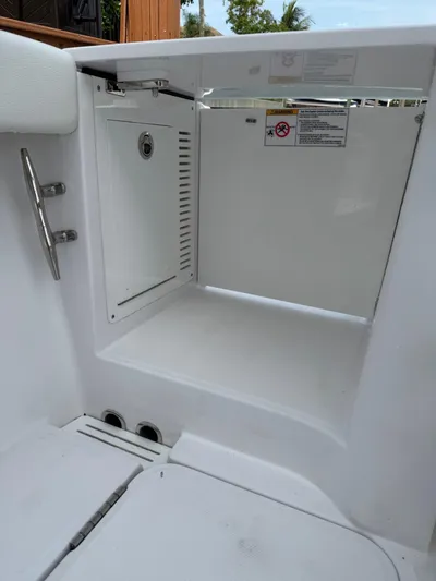  Yacht Photos Pics 2023 Bertram 39 CC boat storage compartment, open and empty, with safety instructions visible.