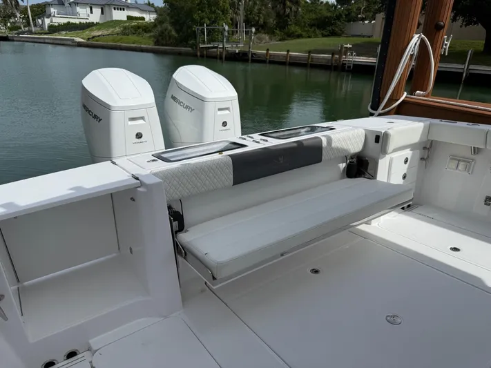 Yacht Photos Pics 2023 Bertram 39 CC boat with Mercury engines, docked by a serene waterfront.