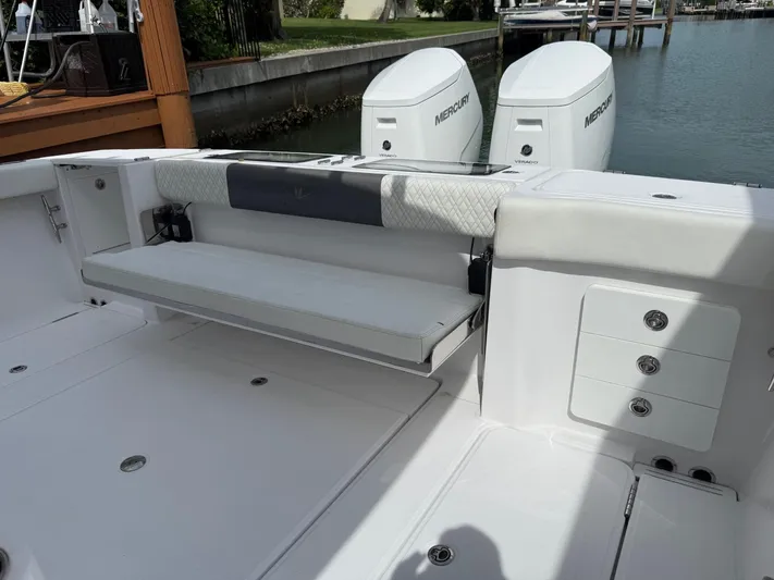  Yacht Photos Pics 2023 Bertram 39 CC boat interior with foldable seat and Mercury engines.