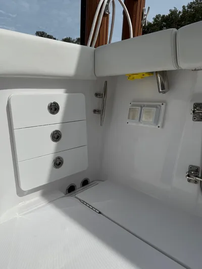  Yacht Photos Pics 2023 Bertram 39 CC boat interior with storage compartments and sleek white design.