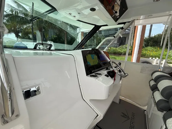  Yacht Photos Pics 2023 Bertram 39 CC boat cockpit with modern steering and navigation system.