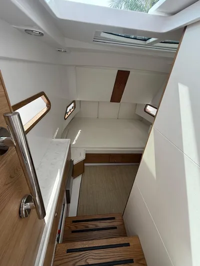  Yacht Photos Pics 2023 Bertram 39 CC cabin interior with wooden accents and modern design.