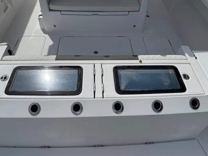  Yacht Photos Pics 2023 Bertram 39 CC boat deck with storage compartments and rod holders.