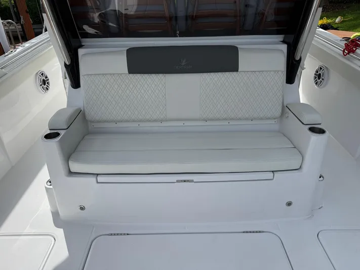  Yacht Photos Pics 2023 Bertram 39 CC boat interior with white cushioned seating and cup holders.