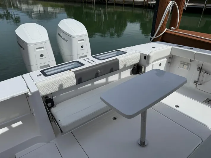  Yacht Photos Pics 2023 Bertram 39 CC boat interior with seating and table, featuring dual Mercury engines.