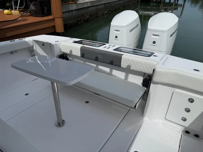  Yacht Photos Pics 2023 Bertram 39 CC boat with dual Mercury engines and sleek seating area.