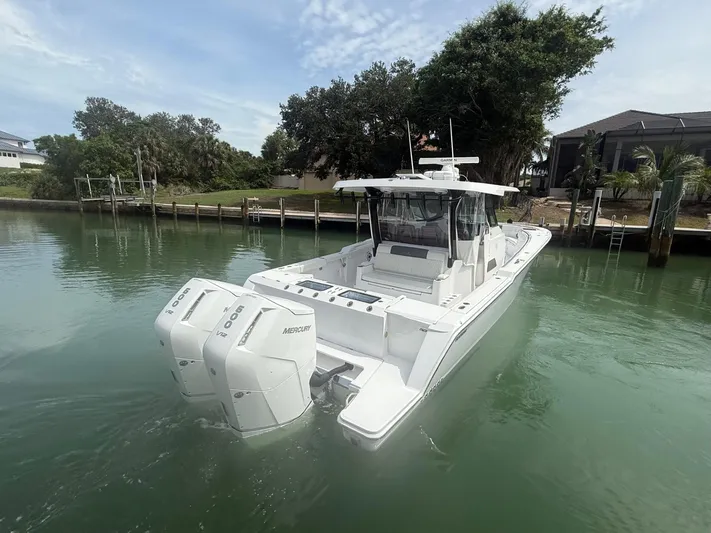  Yacht Photos Pics 2023 Bertram 39 CC boat with twin Mercury engines on calm water.