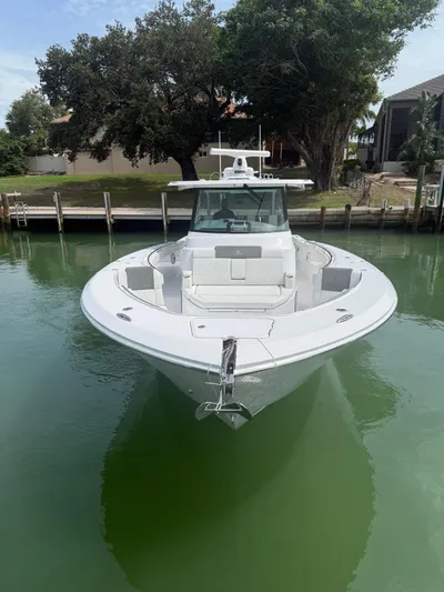 Yacht Photos Pics 2023 Bertram 39 CC boat docked in calm waters, front view.