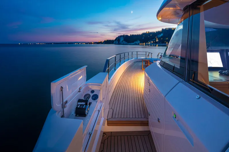  Yacht Photos Pics Luxurious 2023 Custom Line Navetta 30 yacht at sunset, featuring elegant deck lighting.