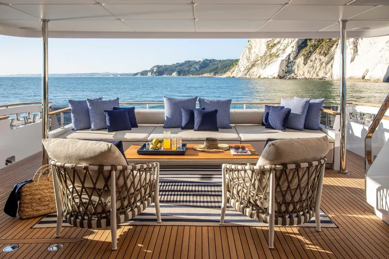  Yacht Photos Pics Luxurious 2023 Custom Line Navetta 30 yacht deck with elegant seating and ocean view.