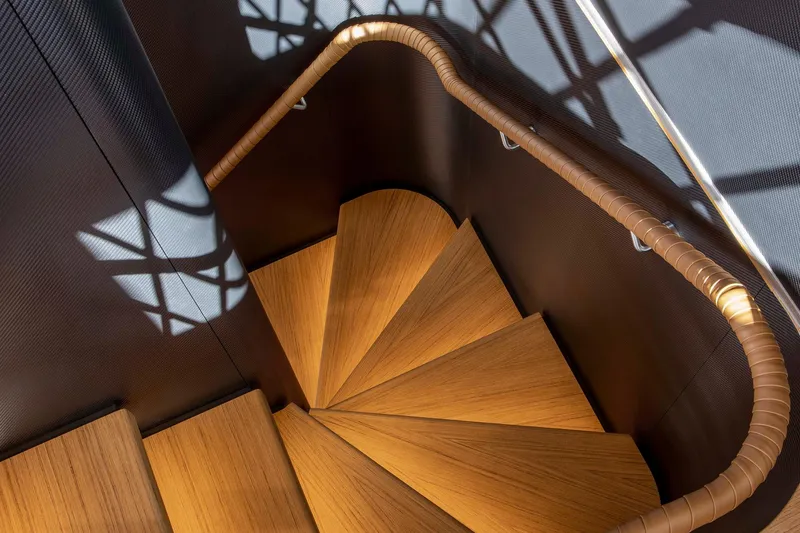  Yacht Photos Pics Spiral staircase on 2023 Custom Line Navetta 30 yacht, featuring wooden steps and elegant design.