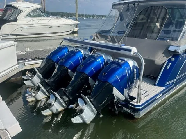  Yacht Photos Pics 2022 Formula 400 Super Sport Crossover with four Mercury outboard engines docked at a marina.