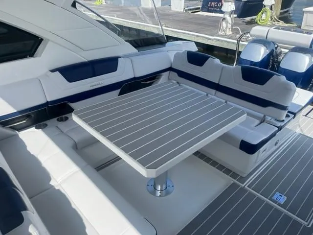  Yacht Photos Pics 2022 Formula 400 Super Sport Crossover boat interior with seating and table.