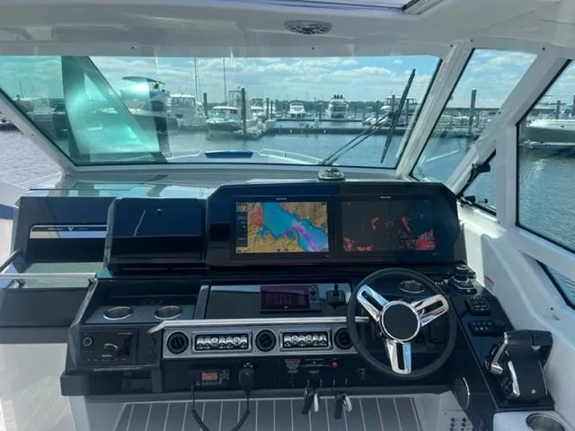  Yacht Photos Pics 2022 Formula 400 Super Sport Crossover helm with advanced navigation system and marina view.