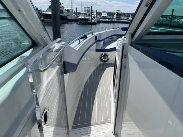  Yacht Photos Pics 2022 Formula 400 Super Sport Crossover boat interior with docked yachts in the background.