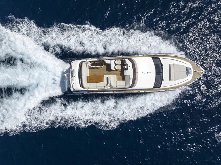  Yacht Photos Pics Aerial view of 2014 Princess 56 yacht cruising on open water.