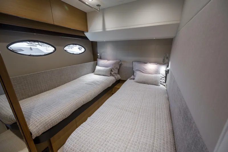  Yacht Photos Pics Twin cabin interior of 2014 Princess 56 yacht with modern design and porthole windows.