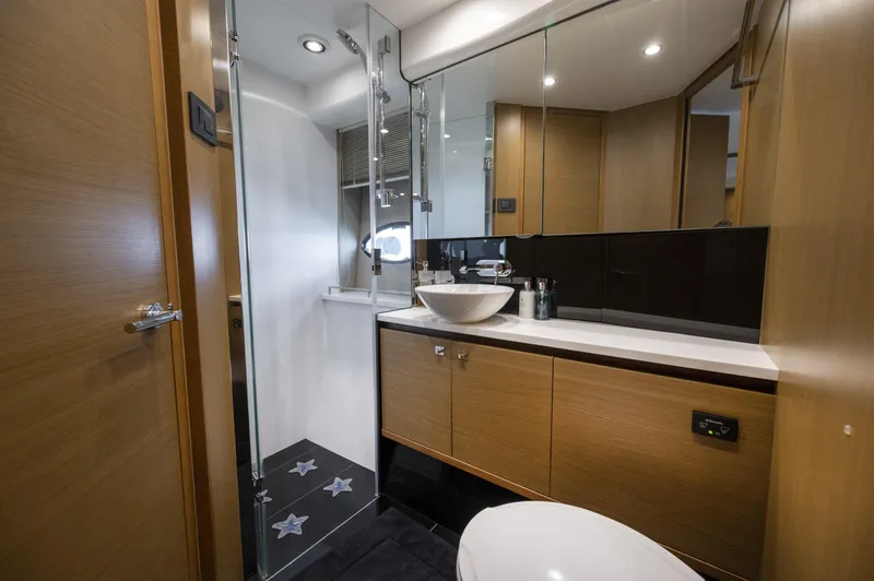  Yacht Photos Pics Luxurious bathroom in 2014 Princess 56 yacht with modern fixtures and elegant design.