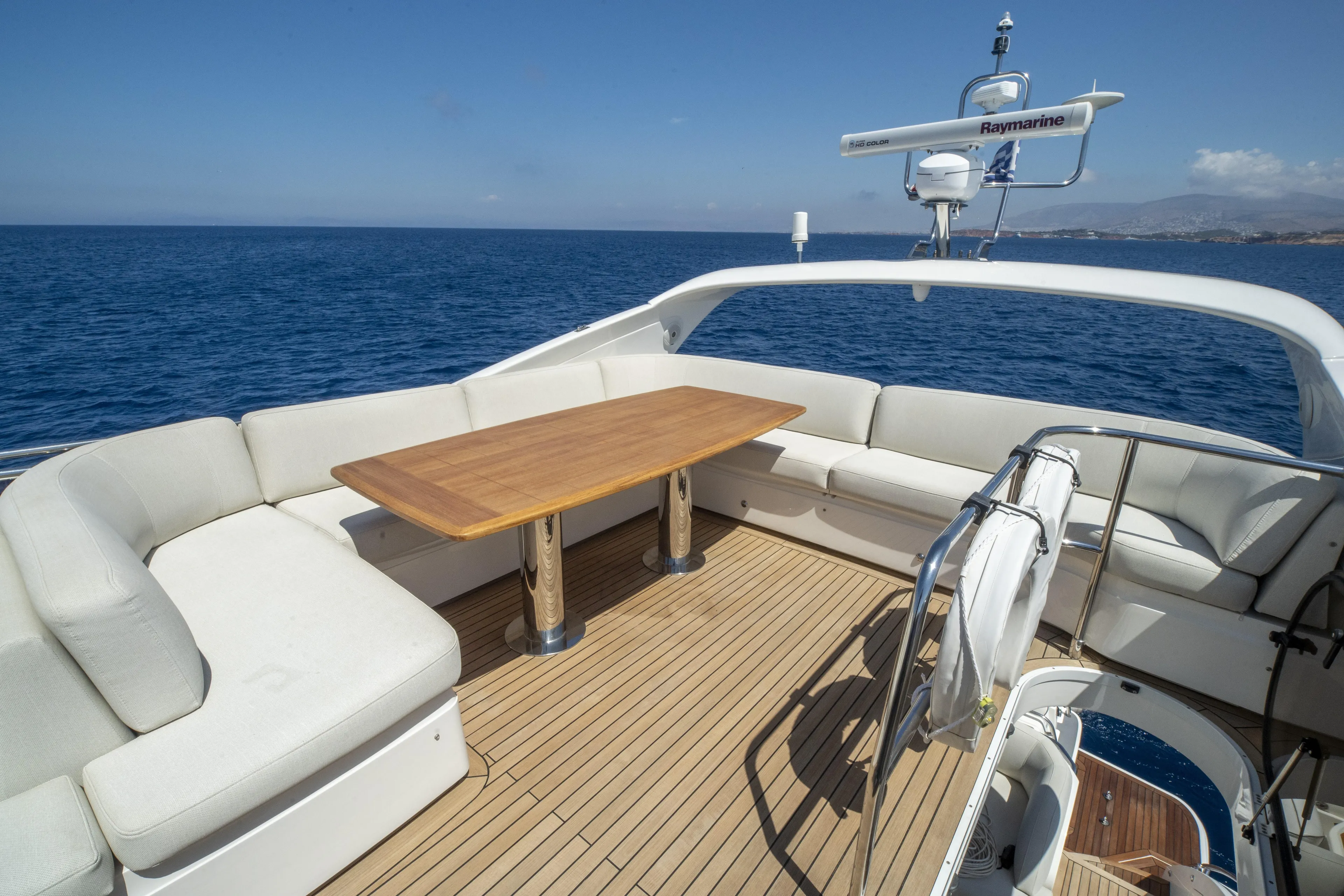  Yacht Photos Pics Luxurious 2014 Princess 56 yacht deck with seating and table, overlooking the ocean.
