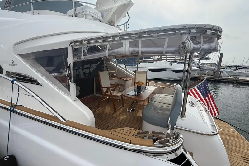 Habibi Yacht Photos Pics Luxurious 2017 Belize 54 Daybridge yacht with elegant deck seating and American flag at marina.