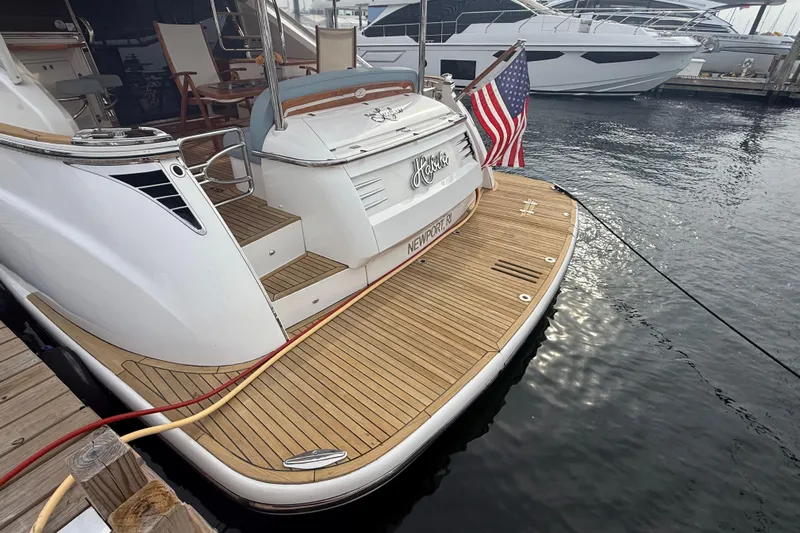 Habibi Yacht Photos Pics 2017 Belize 54 Daybridge yacht docked, featuring a wooden deck and American flag.