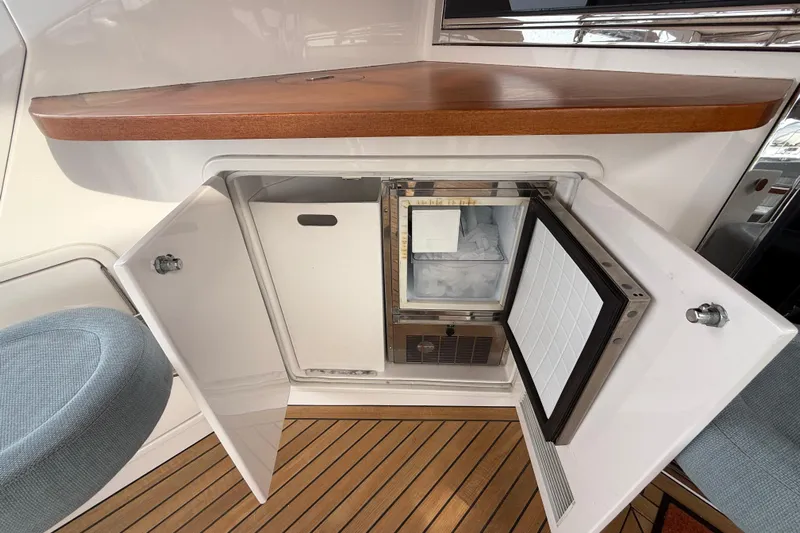 Habibi Yacht Photos Pics Open storage compartment on 2017 Belize 54 Daybridge yacht with wooden countertop.